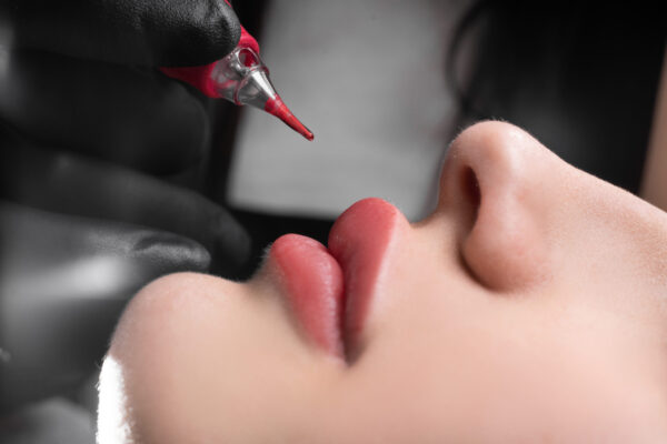 permanent lip makeup in a beauty salon, lip tattoo with coloring pigment, beautiful female lips Lip Liner Tattooing