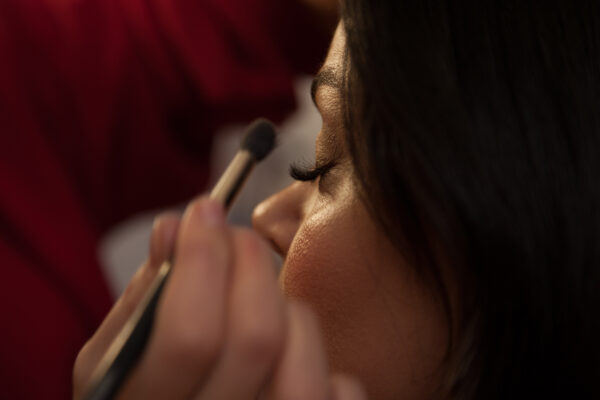 Makeup artist does makeup model. Afro-American models apply make Makeup Service